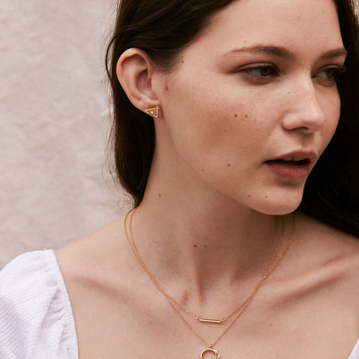 Model wearing Blank Slate Necklace, Squad Necklace, and Tribe Earrings in Gold