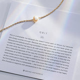 Grit Pearl Necklace in Gold with Description Meaning Card