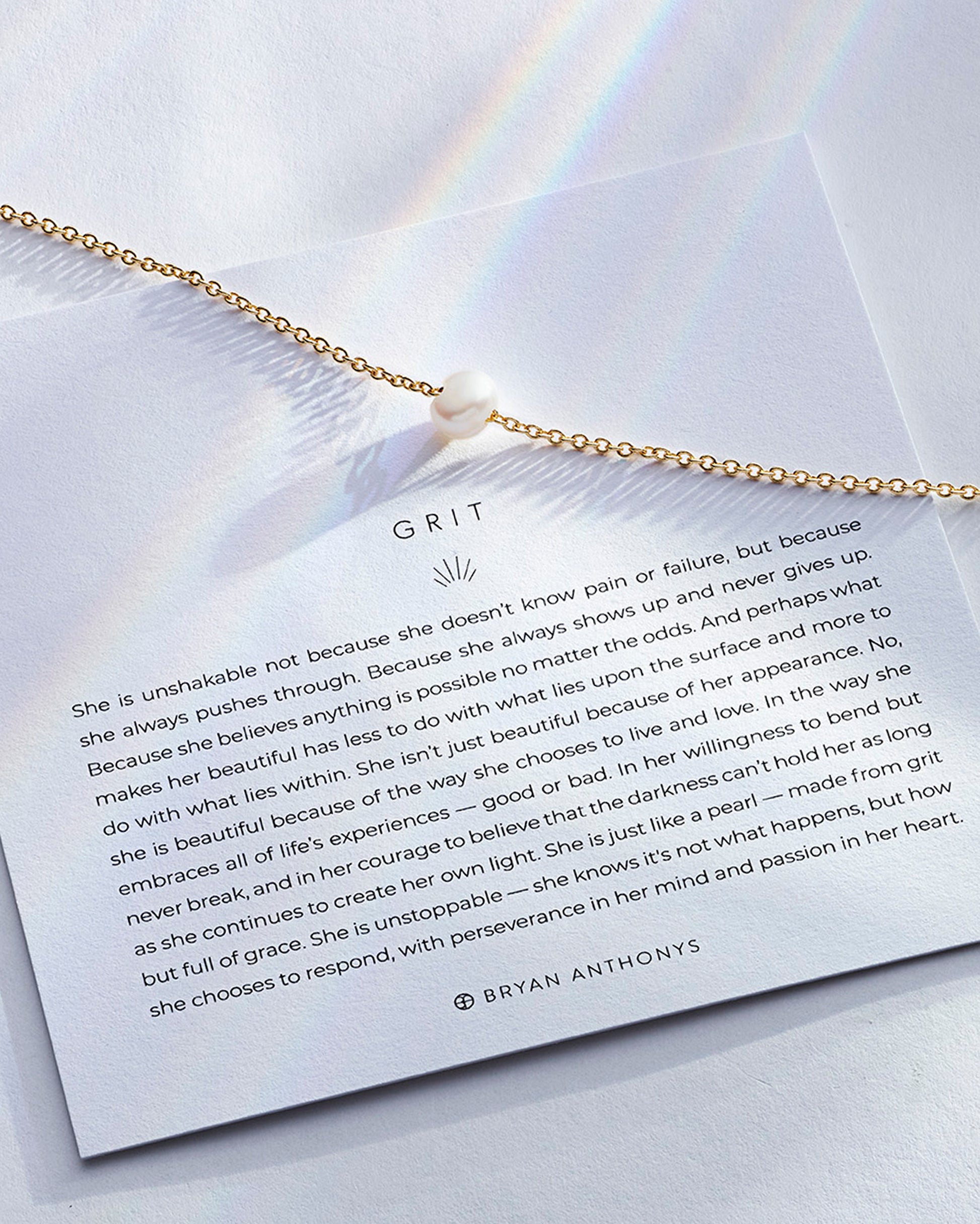 grit necklace in gold on with description card