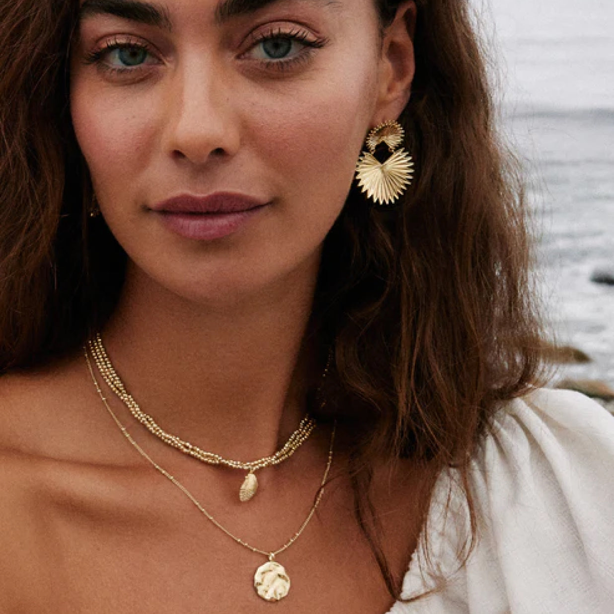 Model wearing beach collection necklaces