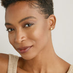 Model wearing Stars Can't Shine Without Darkness Earrings in 14k gold finish