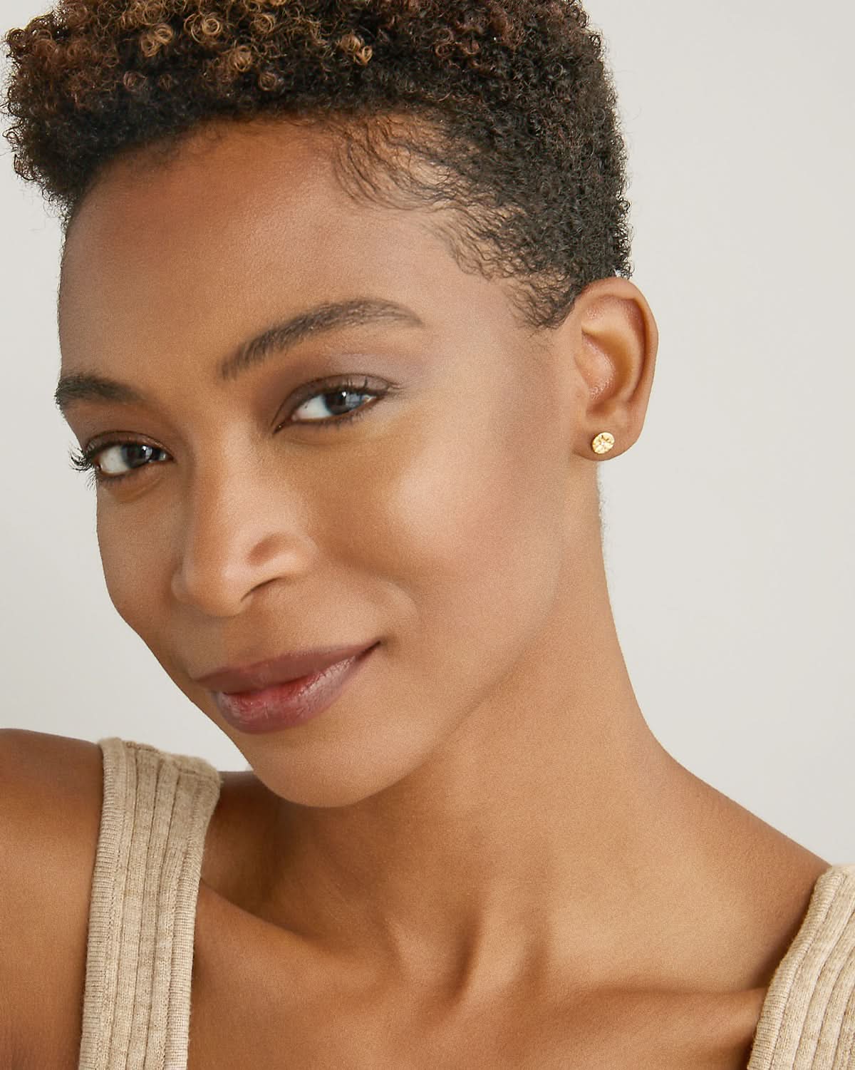 Model wearing Stars Can't Shine Without Darkness Earrings in 14k gold finish