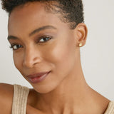 Model wearing Stars Can't Shine Without Darkness Earrings in 14k gold finish