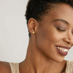 Model wearing Stars Can't Shine Without Darkness Earrings in 14k gold finish