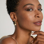 Model wearing Sun Moon & Stars Huggies in 14k gold finish