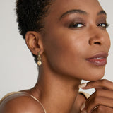 Model wearing Sun Moon & Stars Huggies in 14k gold finish