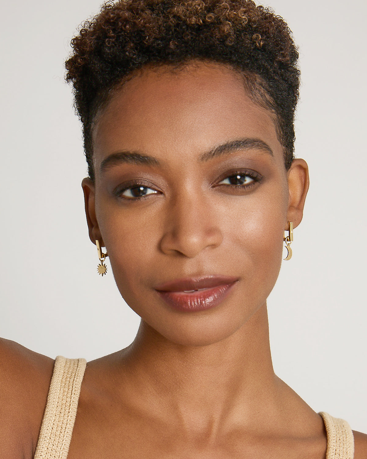 Model wearing Sun Moon & Stars Huggies in 14k gold finish