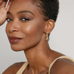 Model wearing Keep Dreaming Huggies in 14k gold finish