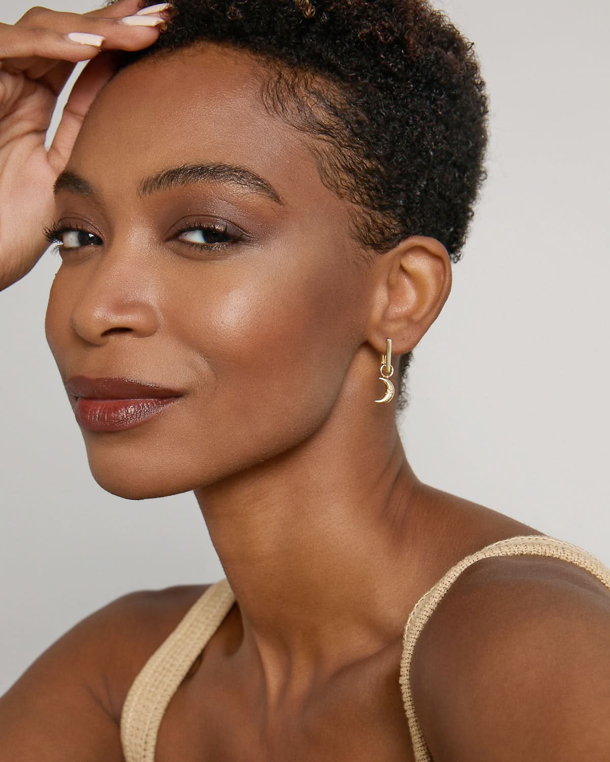 Model wearing Keep Dreaming Huggies in 14k gold finish