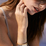 Bryan Anthonys Sea Seeker Gold Hinged Bracelet with sea shell engravings on card