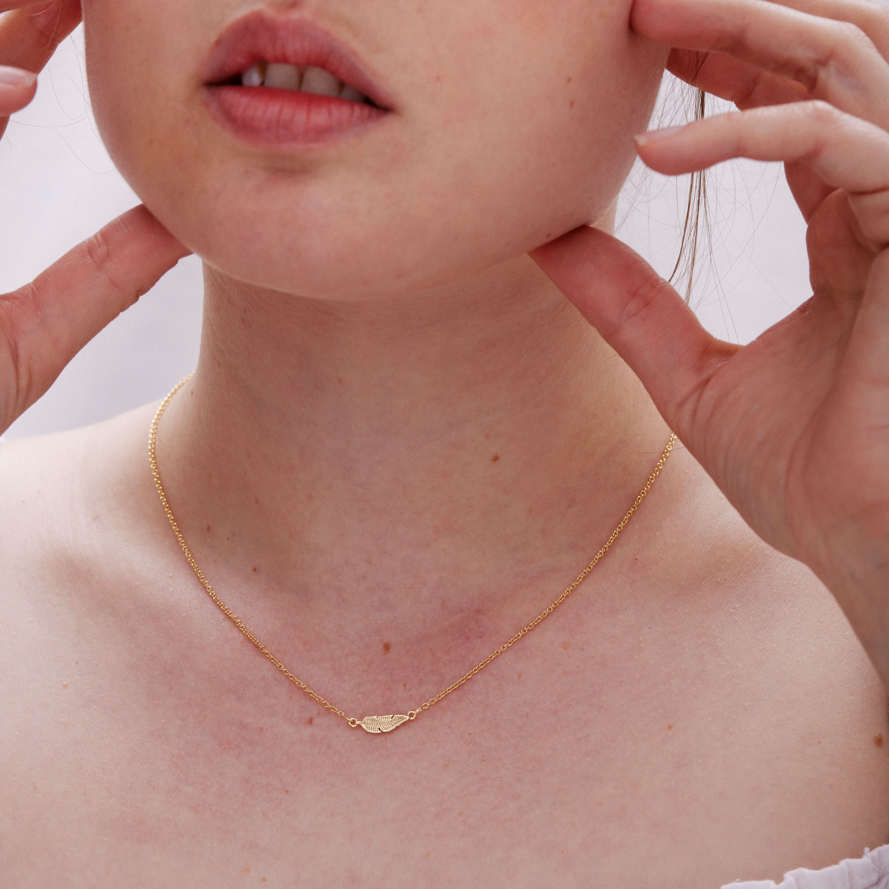 Model wearing Rise Necklace in 14k gold finish