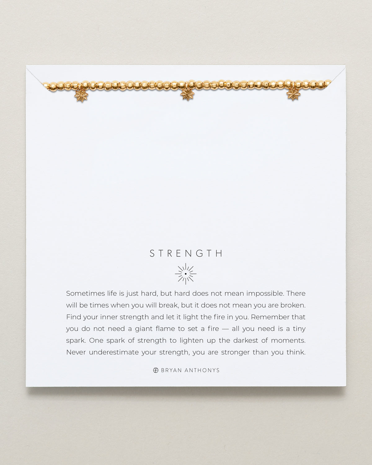 Close-up of Strength Beaded Icon Bracelet in 14k gold finish