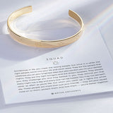 Squad Engraved Cuff showcase in 14k gold on card