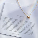 Breathe Necklace showcase in 14k gold on card
