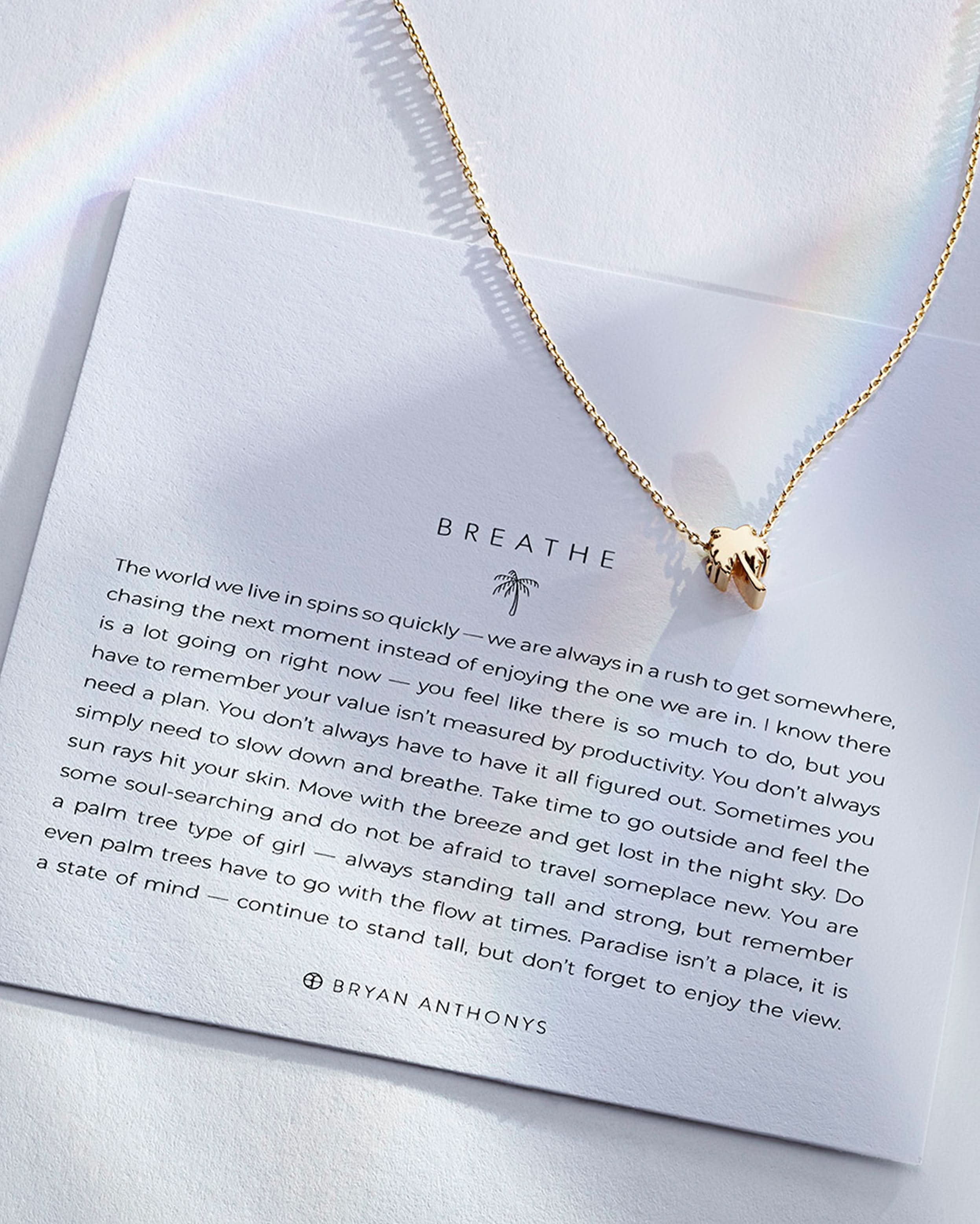 Breathe Necklace showcase in 14k gold on card