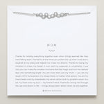 Model wearing Mom Necklace in silver finish