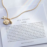Sea Seeker Necklace showcase in 14k gold on card