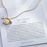 Sea Seeker Necklace showcase in 14k gold on card