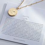 Depth Necklace showcase in 14k gold on card