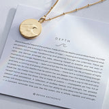 Depth Necklace showcase in 14k gold on card